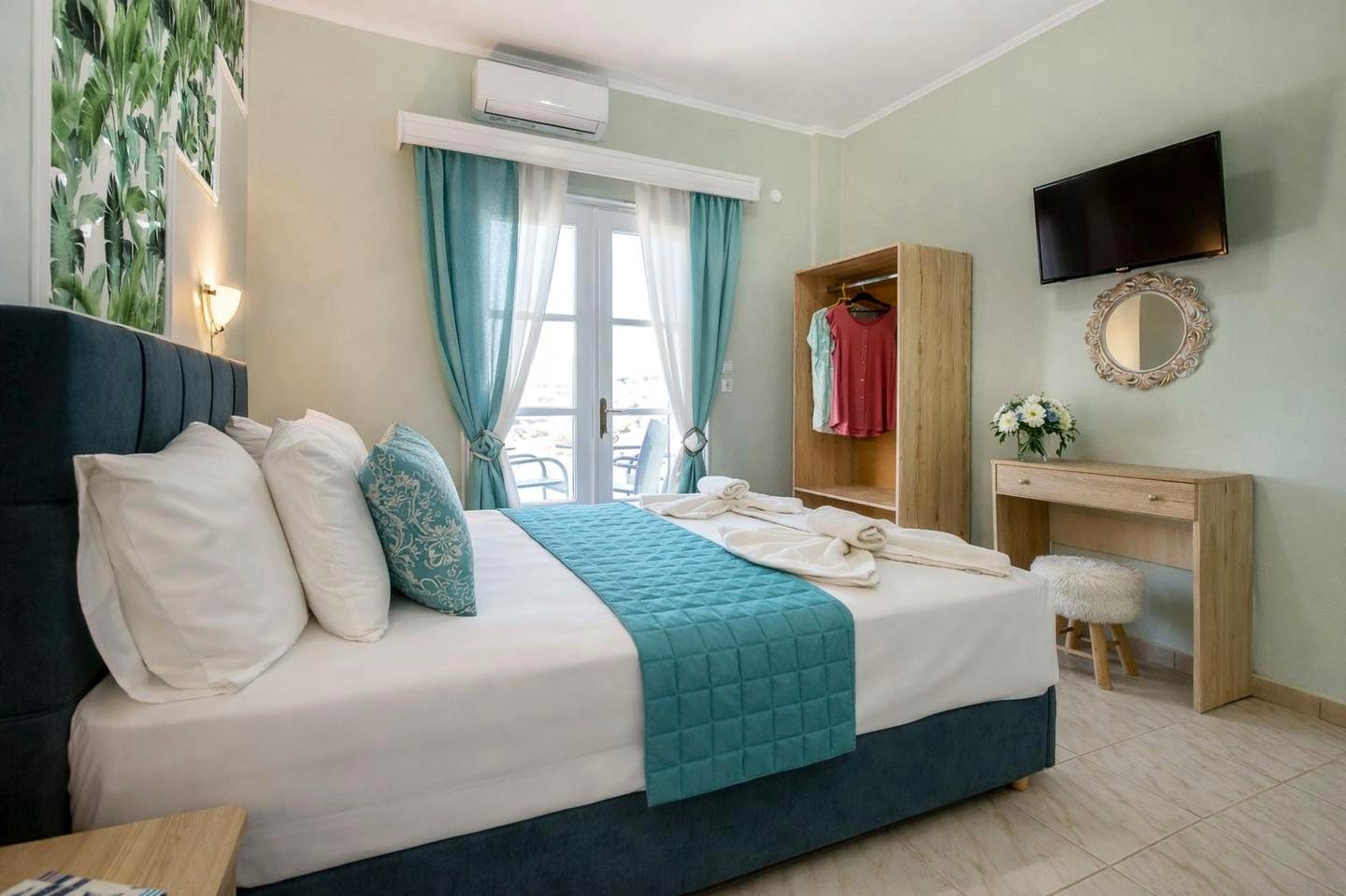 Garden-view bedroom with TV and air conditioning